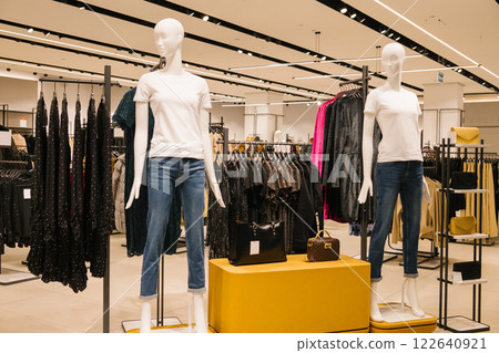 Modern clothing store with mannequins in casual outfits displaying jeans and t-shirts. Last-Minute Shopper's Day Modern clothing store with mannequins in casual outfits displaying jeans and t-shirts. Last-Minute Shopper's Day 122640921