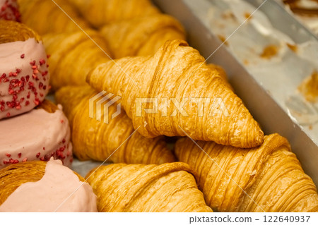 National Croissant Day Golden flaky croissants stacked in a display tray. National Croissant Day Golden flaky croissants stacked in a display tray. 122640937