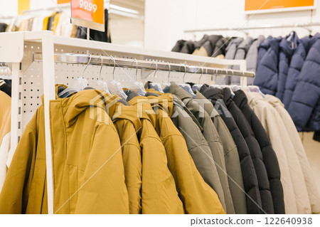 Winter coats displayed in clothing store with various colors and styles. National Thrift Shop Day Winter coats displayed in clothing store with various colors and styles. National Thrift Shop Day 122640938