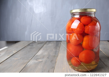 Salted tomatoes, homemade vegetable preparations on a gray background with space for copyspace text 122641327