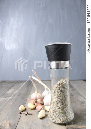 Peeled garlic and heads of white purple garlic on gray foon with space for salt shaker text 122641333