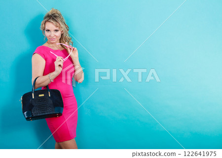 Mature fashion woman holds handbag Mature fashion woman holds handbag 122641975