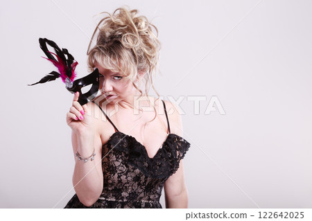 Woman middle aged holds carnival mask. Woman middle aged holds carnival mask. 122642025