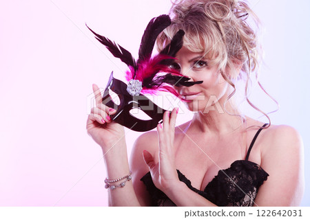 Woman middle aged holds carnival mask. 122642031