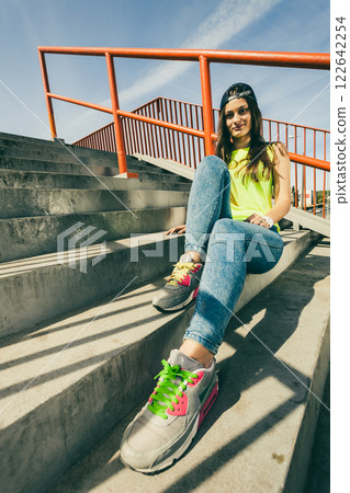 Girl on stairs with skateboard. Girl on stairs with skateboard. 122642254
