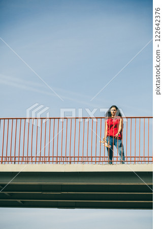Urban skate girl with skateboard. Urban skate girl with skateboard. 122642376