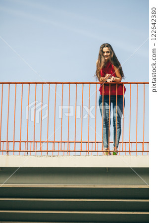Girl on bridge in city. 122642380