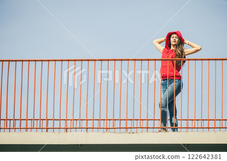 Girl on bridge in city. 122642381