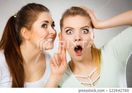 Two women telling gossip 122642760