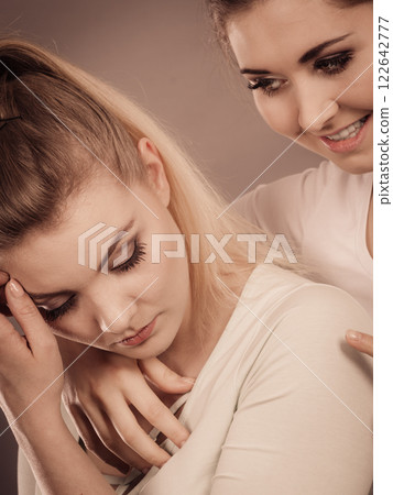 Woman hugging her sad female friend 122642777