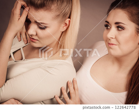 Woman hugging her sad female friend Woman hugging her sad female friend 122642778