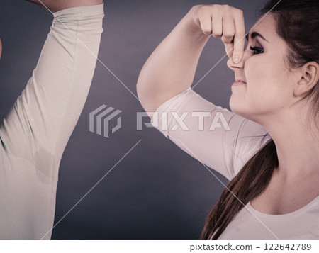 Woman having wet armpit her friend smelling stink 122642789