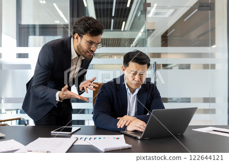 Conflict in the office, stress and aggression in the workplace, male boss yelling at subordinate, businessman not satisfied with work results and achievements. 122644121