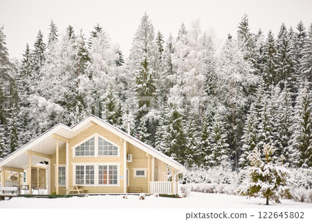 beautiful country house in a snowy pine forest, night lighting, winter fairy tale beautiful country house in a snowy pine forest, night lighting, winter fairy tale 122645802