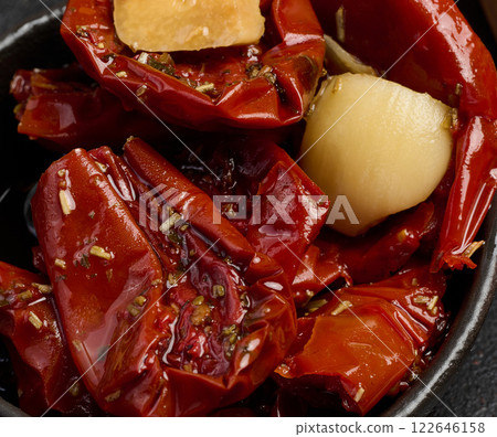 Sun dried tomatoes in a bowl and sliced loaf pieces 122646158