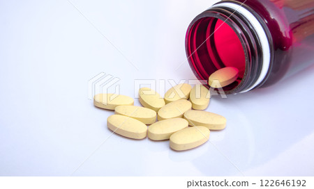 Open Medicine Bottle with Scattered Pills, Pharmaceutical Healthcare Background, Close-up 122646192