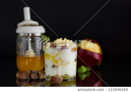 sweet homemade yogurt in a glass with apples, nuts and honey 122646268