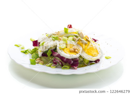 Light salad with egg in a plate, isolated on white background 122646279
