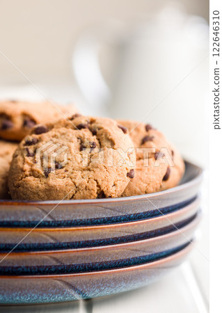 Chocolate chip cookies on plate on white table. 122646310