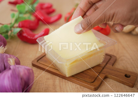 Fresh Slice of Cheese with Vegetables on Wooden Table Fresh Slice of Cheese with Vegetables on Wooden Table 122646647