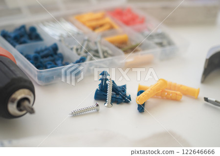 Tools and fasteners spread on a work surface for home improvement projects Tools and fasteners spread on a work surface for home improvement projects 122646666