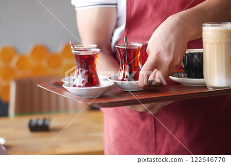 Waiter Serving Traditional Tea and Coffee in Cozy Caf 122646770