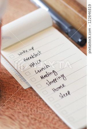 To do list in notebook with office suppliers on desk. 122646819