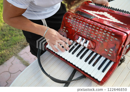 Hands Of A Player Preparing To Play Accordion  122646850