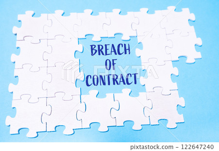 Jigsaw puzzle with the word BREACH of contract written in blue 122647240