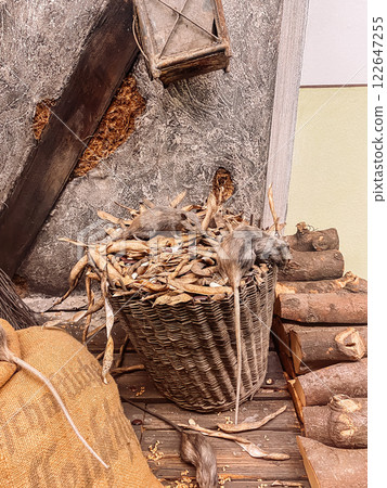 Basket full of mice is sitting on a pile of wood Basket full of mice is sitting on a pile of wood 122647255