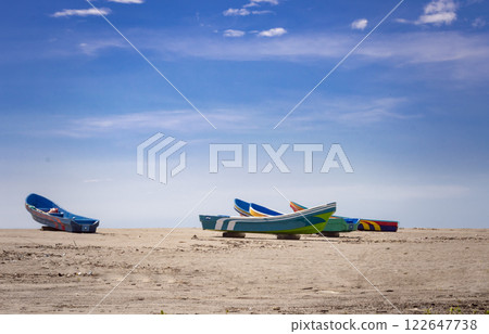 four boats parked on the sand, fishing boats parked near the ocean, boats stranded on the ocean shore with blue sky four boats parked on the sand, fishing boats parked near the ocean, boats stranded on the ocean shore with blue sky 122647738
