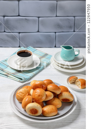 Sweet cardamom spiced buns, pulla, on a plate Sweet cardamom spiced buns, pulla, on a plate 122647950