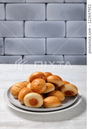 Sweet cardamom spiced buns, pulla, on a plate Sweet cardamom spiced buns, pulla, on a plate 122647951