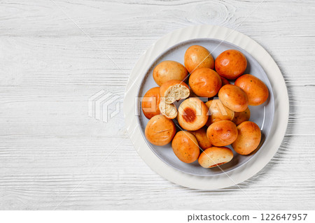Sweet cardamom spiced buns, pulla, on a plate Sweet cardamom spiced buns, pulla, on a plate 122647957