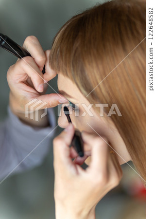 Portrait of make-up artist doing make-up girl. Portrait of make-up artist doing make-up girl. 122648582