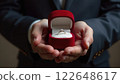A man holding a red velvet box with a diamond engagement ring. Concept of commitment. 122648617