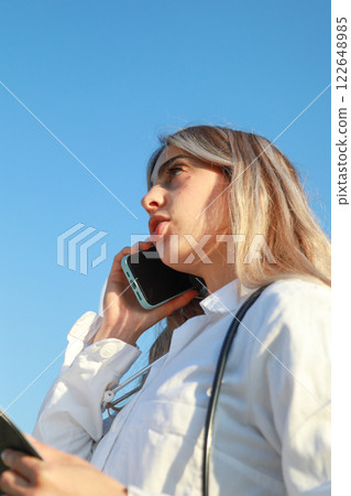 Dedicated Physician Communicating Urgently in Open Air 122648985