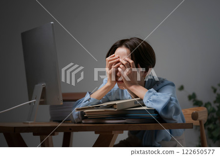A woman snoozers at work A woman snoozers at work 122650577