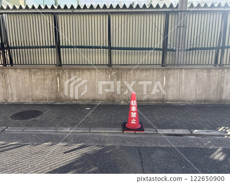 A road with a red cone saying "No Parking" A road with a red cone saying "No Parking" 122650900