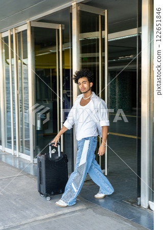 Young tourist arriving with his suitcase at his destination. 122651846