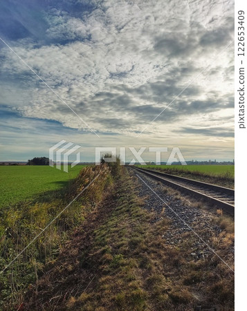 Railway line among sown fields 122653409