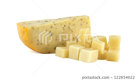 Piece of cumin cheese with cubes showing its texture on white background 122654022