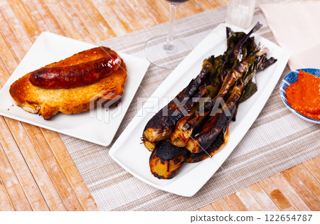 Traditional spanish foods - calsot, romesco, butifarra closeup Traditional spanish foods - calsot, romesco, butifarra closeup 122654787