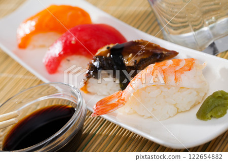 Nigiri with fresh salmon, tuna, eel and shrimp Nigiri with fresh salmon, tuna, eel and shrimp 122654882
