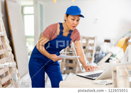 Female engineer using laptop during repair works Female engineer using laptop during repair works 122655051