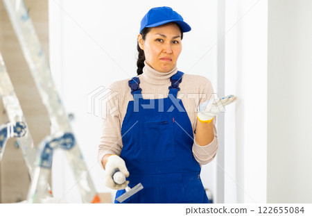 Portrait of disenchanted woman repair worker Portrait of disenchanted woman repair worker 122655084