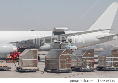 Loading a car into a cargo airplane. Freight aircraft ground handling 122656149