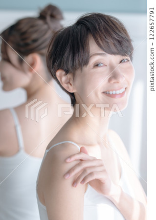 Beauty image of a middle-aged woman bathed in the morning sun 122657791