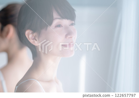 Beauty image of a middle-aged woman bathed in the morning sun 122657797