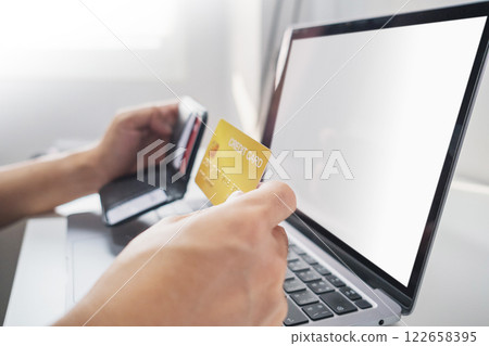 Close-up of hand holding credit card from wallet to online shopping. Cashless technology and credit card payment concept. Close-up of hand holding credit card from wallet to online shopping. Cashless technology and credit card payment concept. 122658395